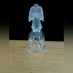 A vintage frosted angel sits atop a crystal bell etched with the year 2001.